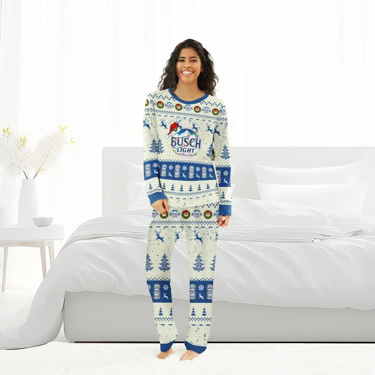 Smiling woman wearing Busch Light Christmas reindeer family pajamas in bright bedroom
