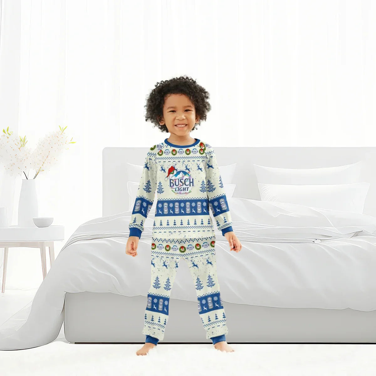Smiling child in Busch Light Christmas reindeer family pajamas standing in bright white bedroom
