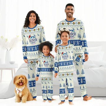 Family in matching Busch Light Christmas reindeer pajamas standing in bright modern bedroom with dog