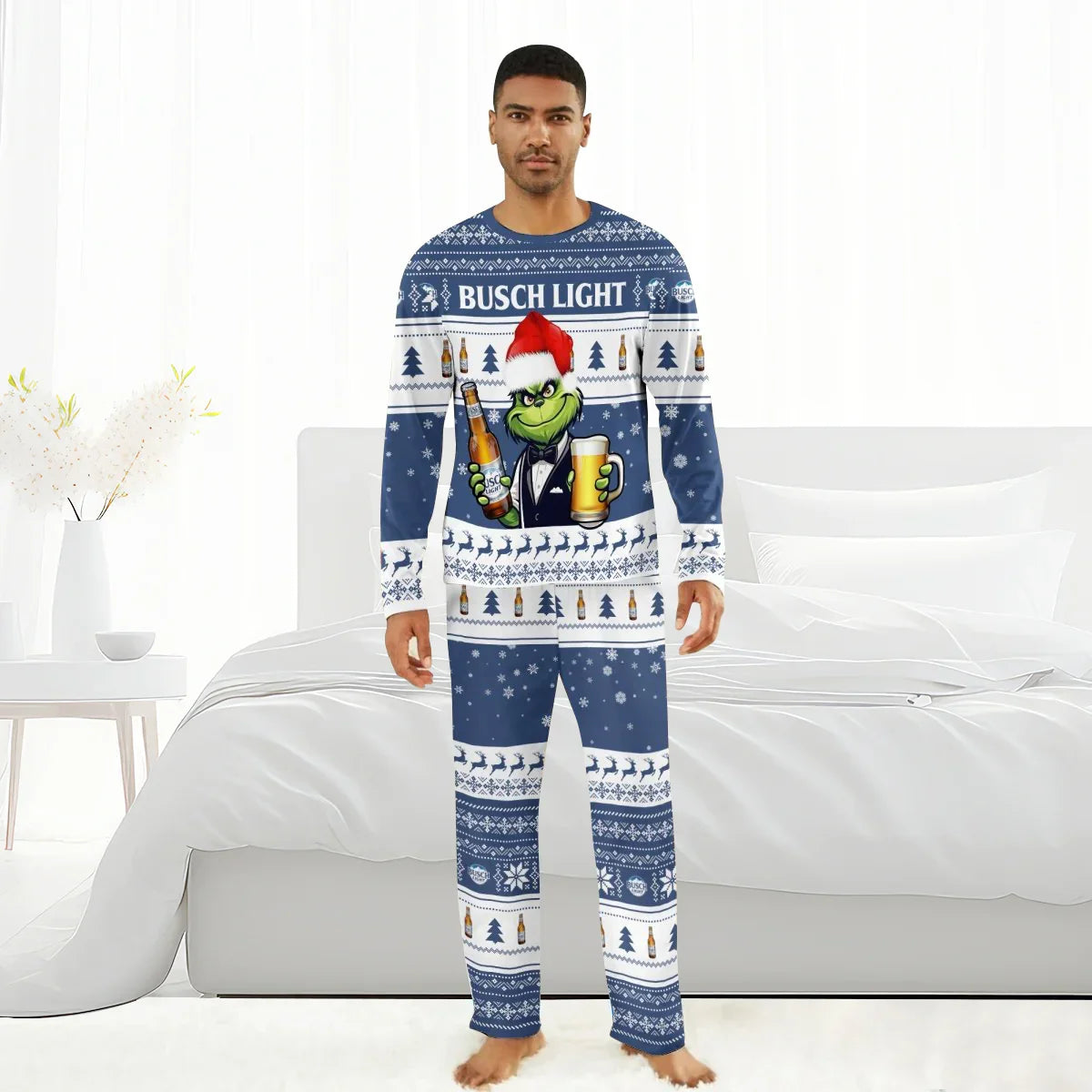 Man wearing Busch Light Christmas pajamas with Grinch holding beer bottle and glass in bedroom