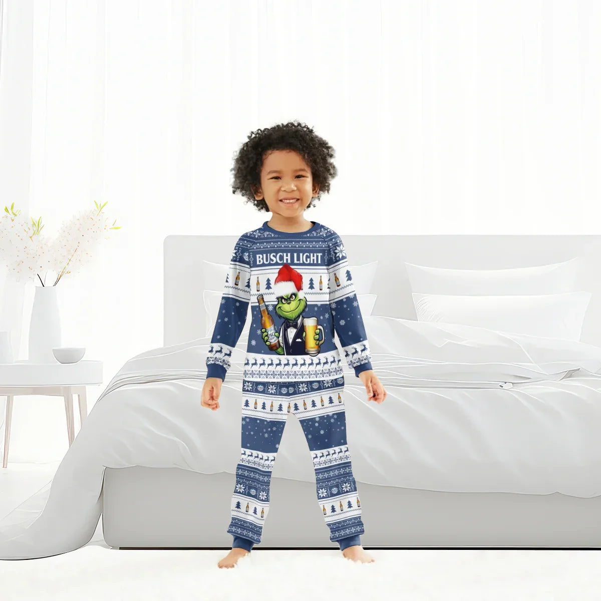 Smiling child wearing Busch Light Grinch Christmas pajama set in bright modern bedroom