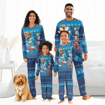 Smiling family in matching blue Christmas pajamas with Busch Light holiday design, indoor setting