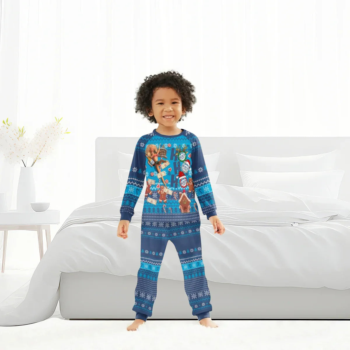 Smiling child in blue holiday pajamas with gingerbread and North Pole designs in bright bedroom