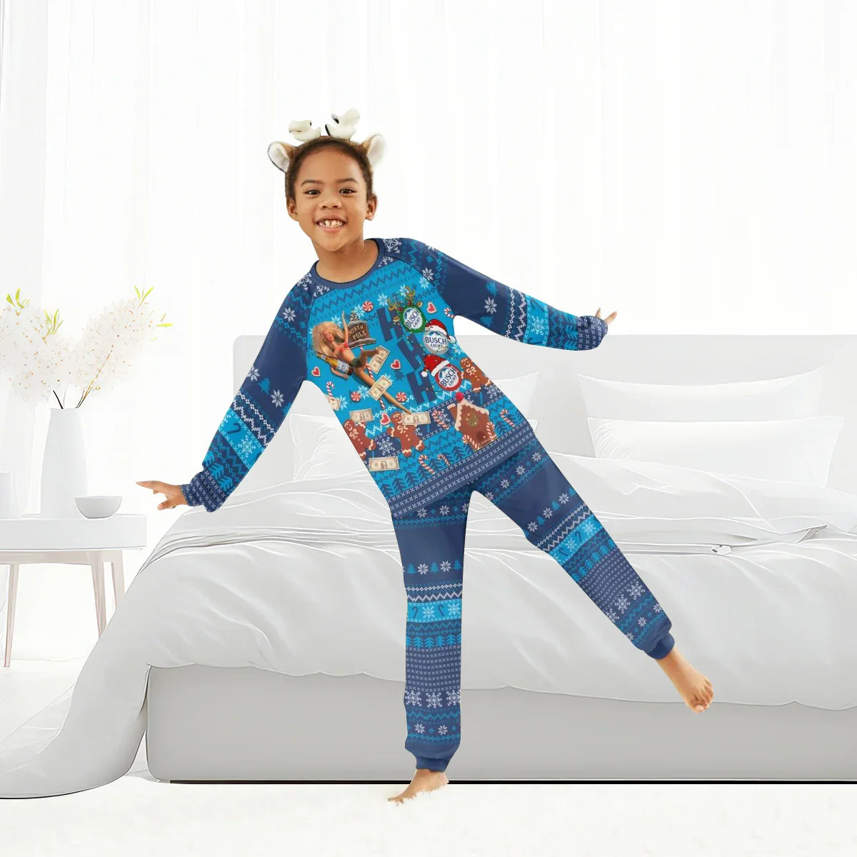Smiling child wearing blue festive Busch Light Christmas pajamas with gingerbread and candy designs in bright bedroom