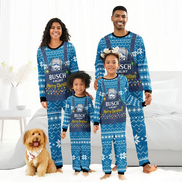 Smiling family of four and dog in matching blue Busch Light Christmas pajamas in cozy living room
