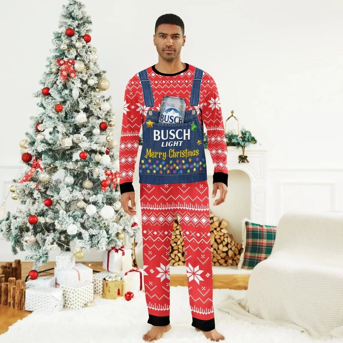 Man wearing red Christmas pajamas with Busch Light Merry Christmas overalls print beside decorated Christmas tree