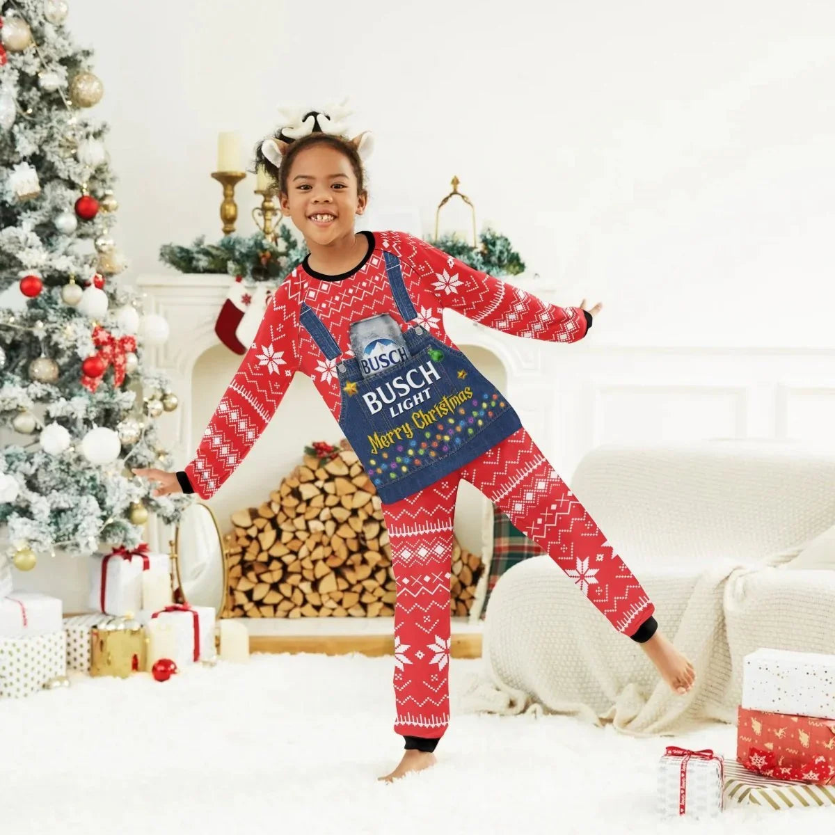 Child wearing red Busch Light Merry Christmas holiday pajamas with reindeer headband in festive living room
