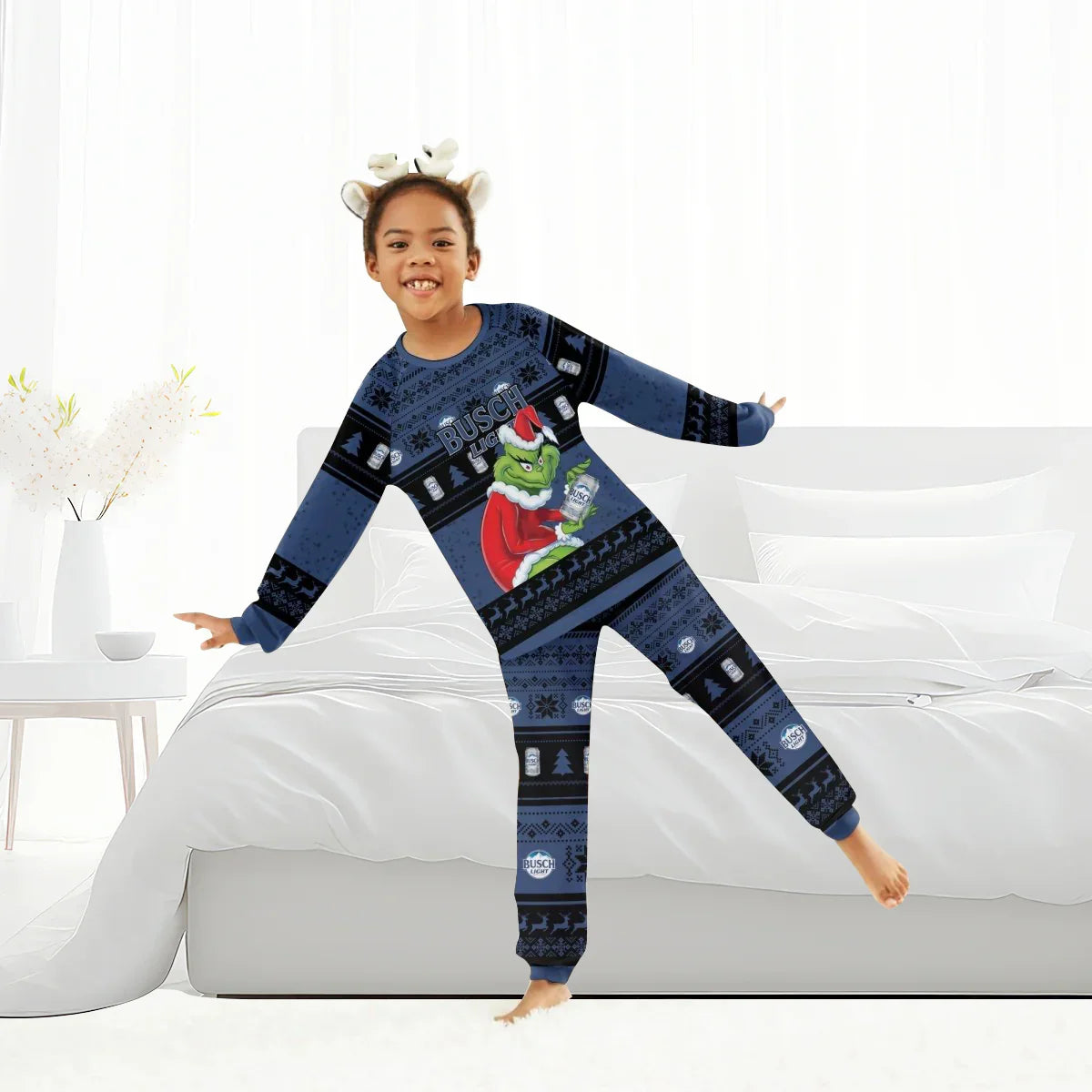 Child in blue Busch Light pajamas with Grinch holding beer can, dancing in bright bedroom