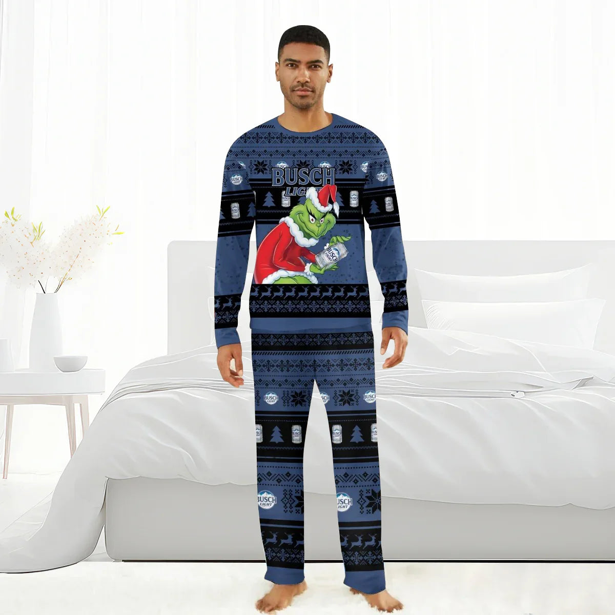 Man wearing blue Busch Light Christmas pajamas with Grinch holding a Busch Light can