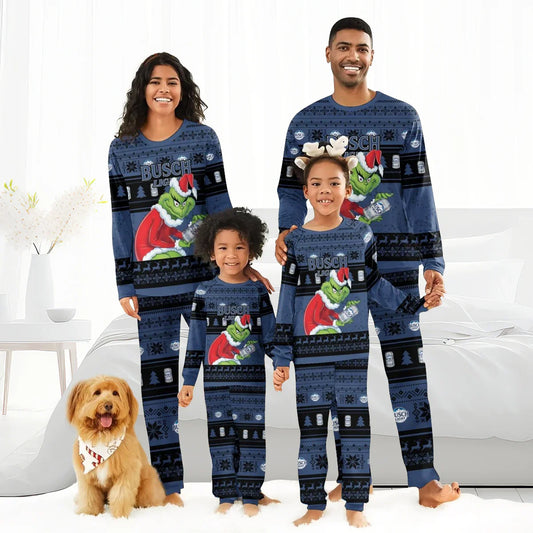 Family wearing matching blue Busch Light Grinch Christmas pajamas in a bright cozy bedroom with dog