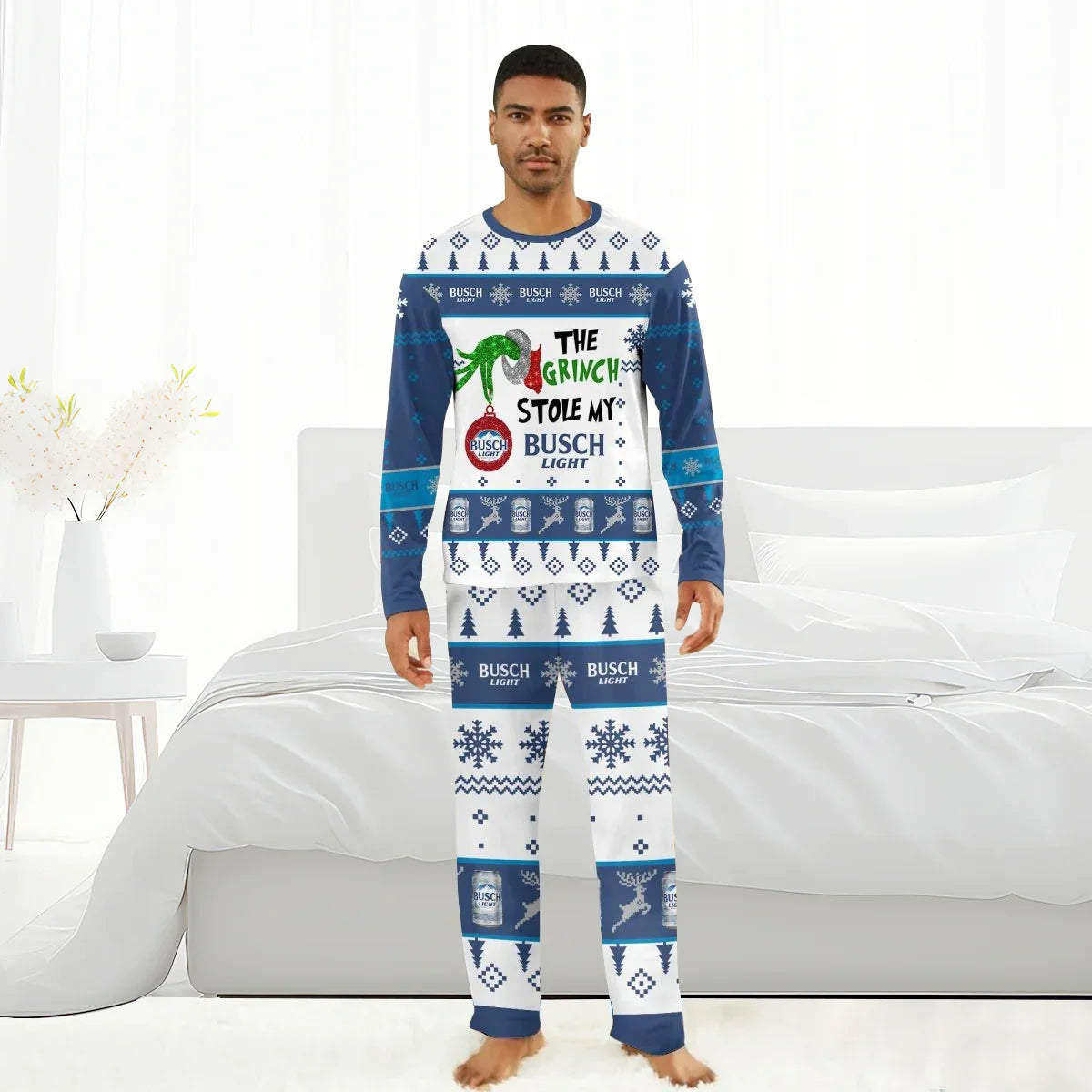 Man wearing Busch Light Grinch-themed Christmas pajamas with holiday patterns in bright bedroom