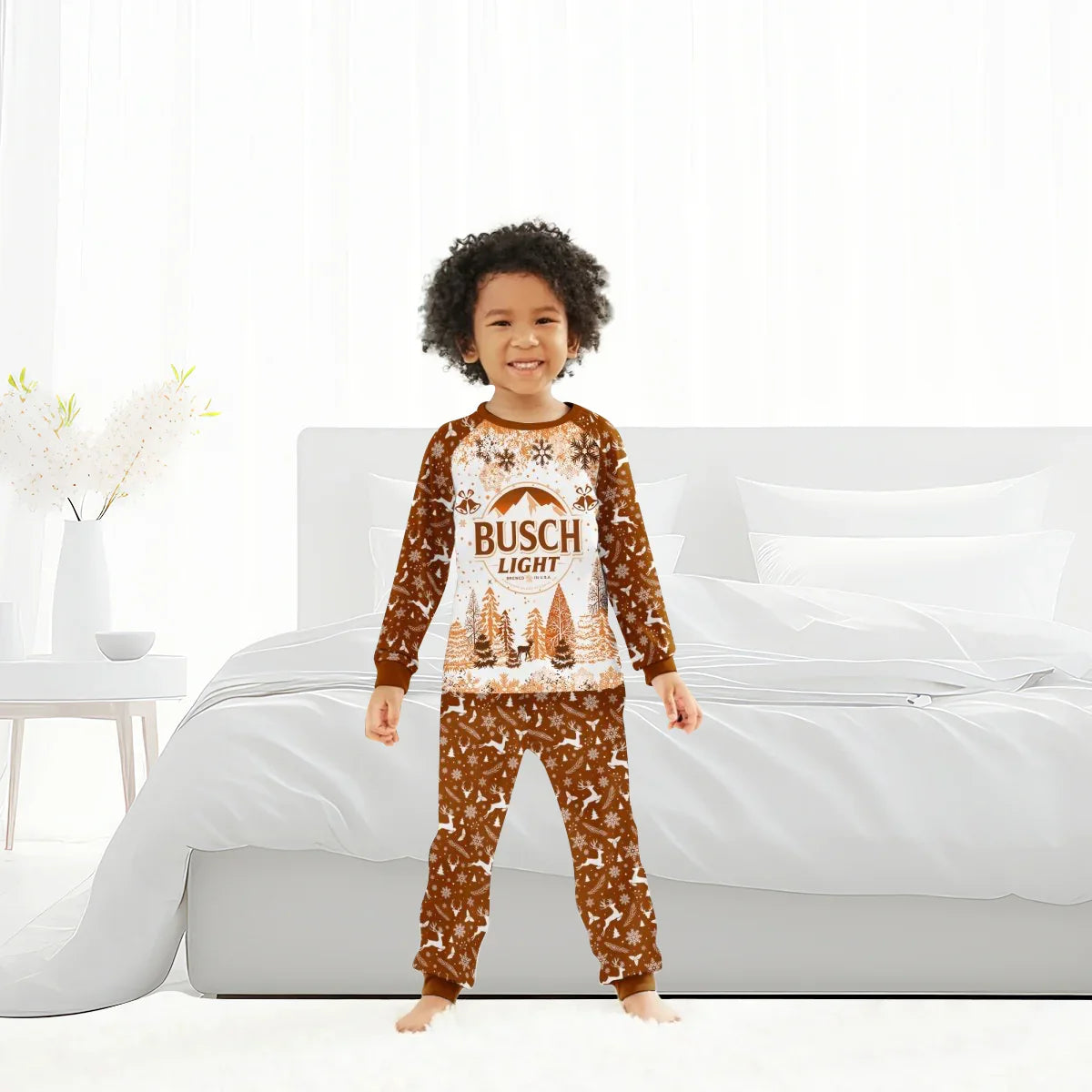 Happy child wearing Busch Light Christmas pajama set with snowflakes and reindeer in bright bedroom