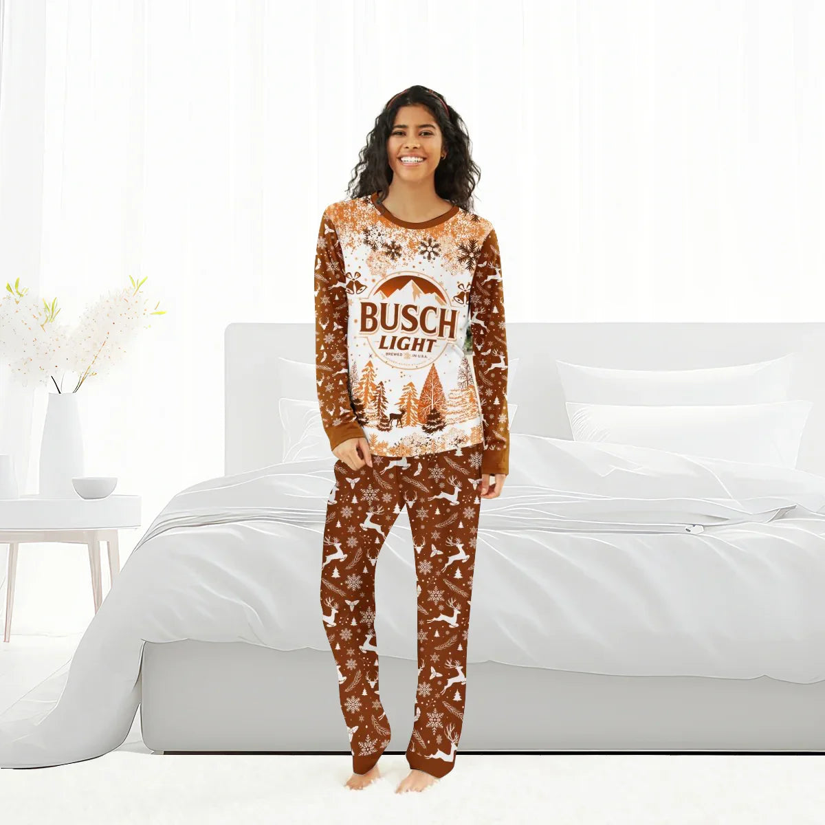 Smiling woman wearing brown and white Busch Light holiday pajama set with snowflakes and reindeer