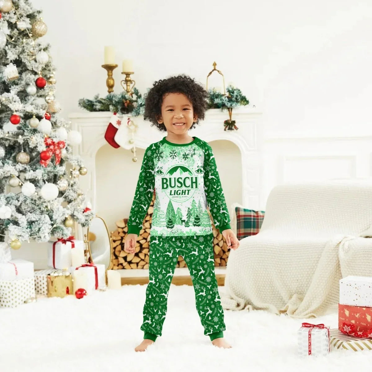Child in green Busch Light Christmas pajamas standing in festive living room with decorated tree and wrapped gifts