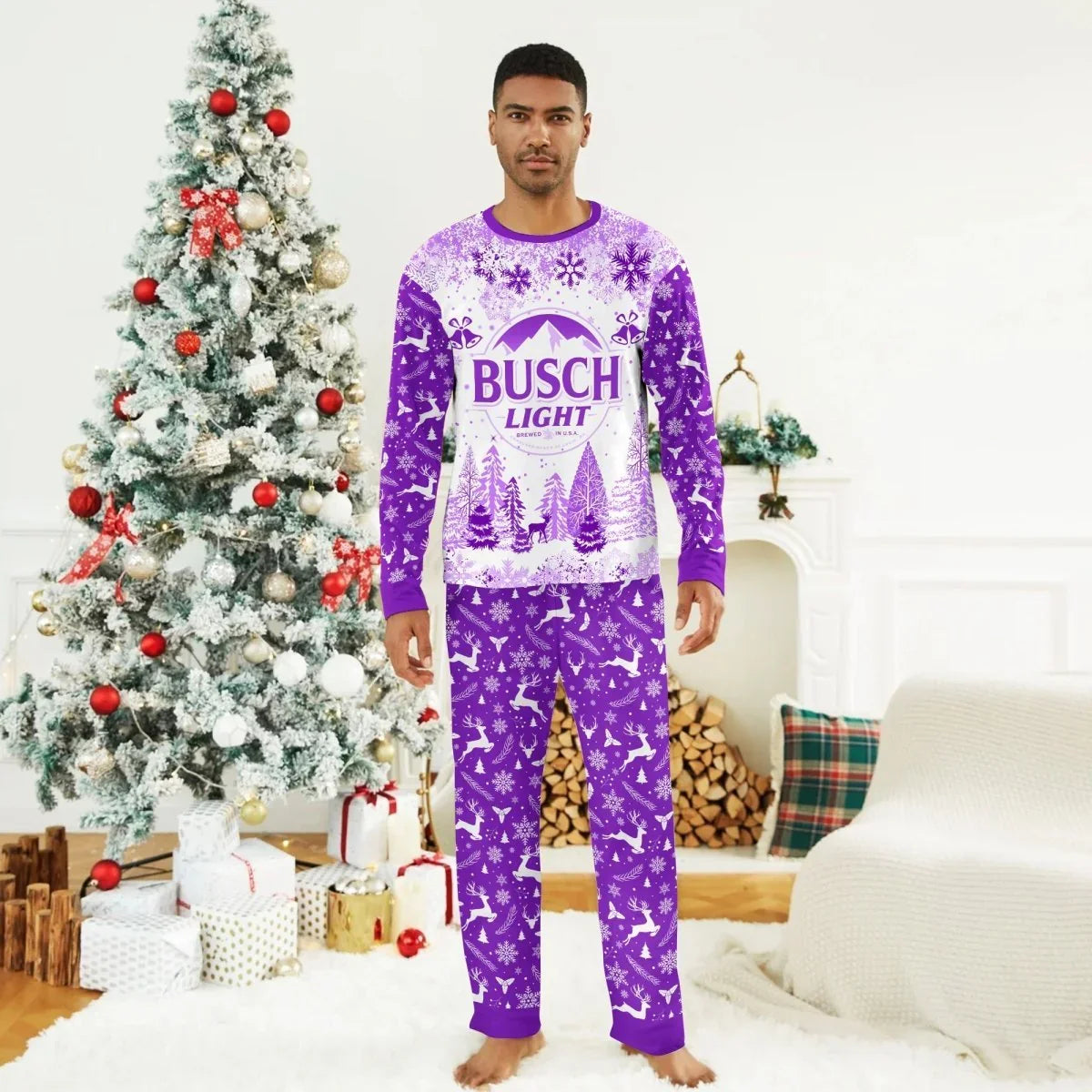 Man wearing purple and white Busch Light winter Christmas pajamas standing by decorated tree and fireplace