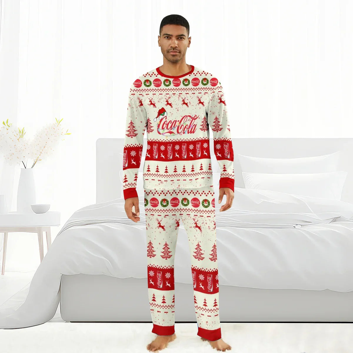 Man wearing Coca-Cola Christmas pajama set with reindeer, trees, wreaths, and Santa hat logo in white and red