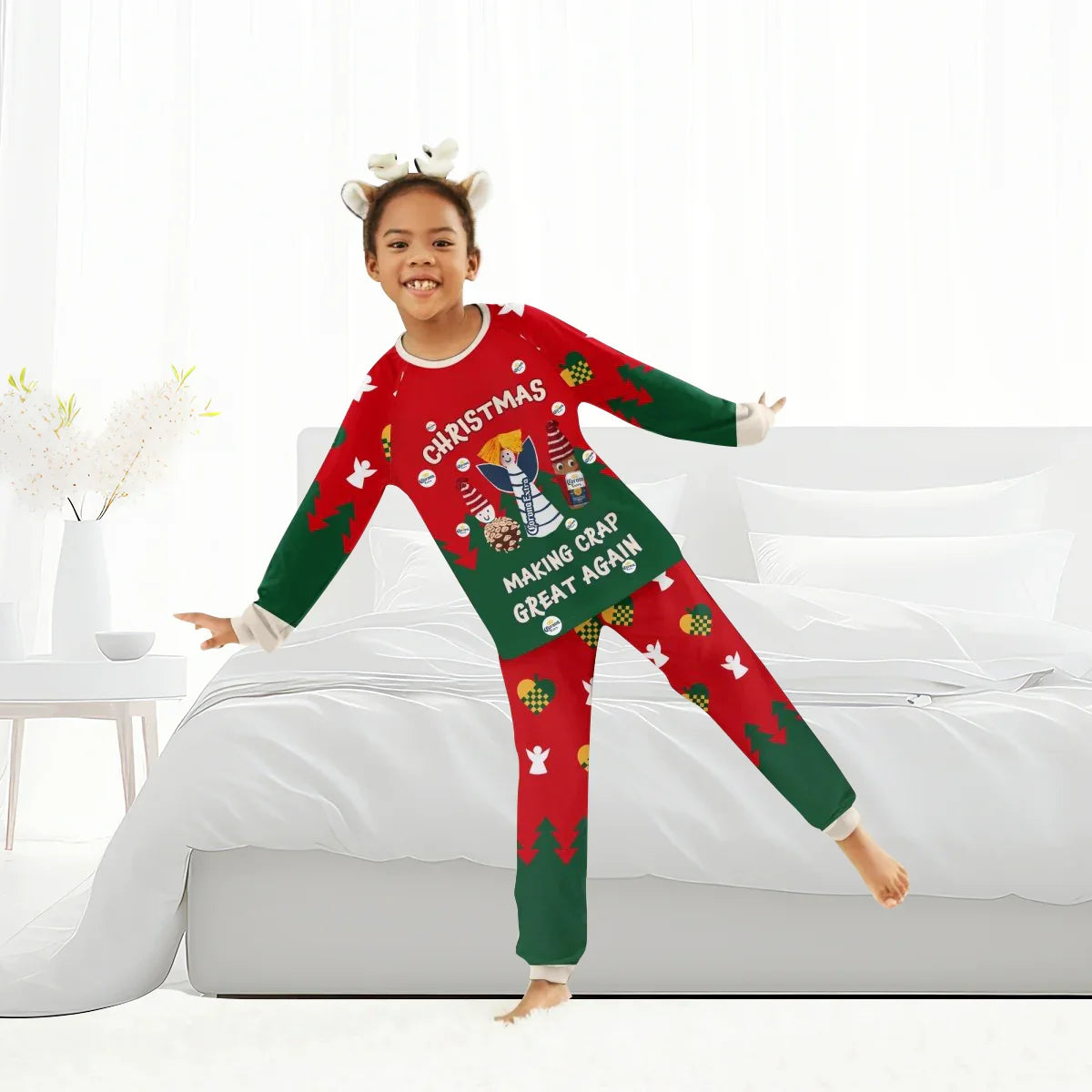 Smiling child in festive red and green Christmas pajamas with beer bottle and angel graphics, standing in bright bedroom