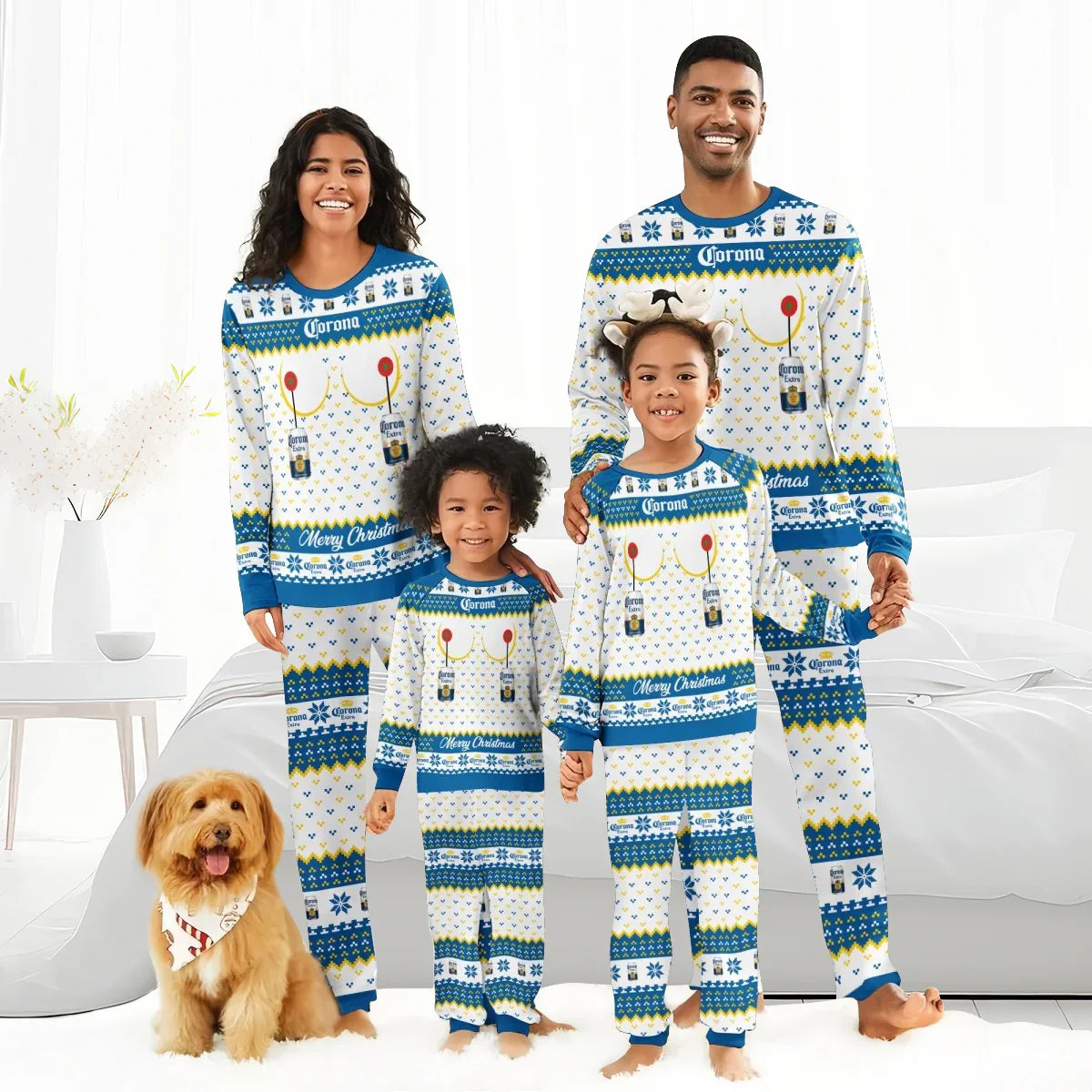 Smiling family wearing matching Corona Extra Christmas pajamas posing with dog in bright bedroom