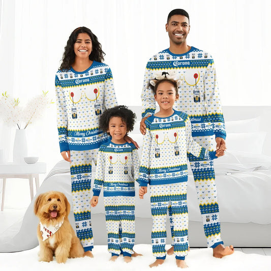 Smiling family wearing matching Corona Extra Christmas pajamas posing with dog in bright bedroom
