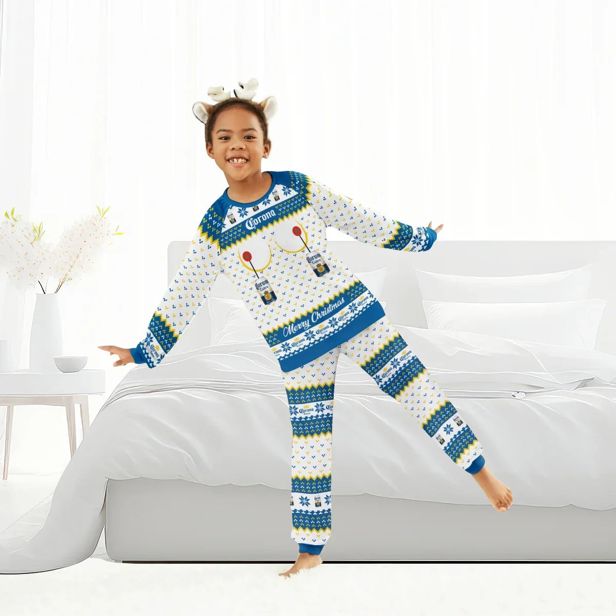 Child in white and blue Corona Extra Christmas pajamas with beer bottle design, posing in a bright bedroom