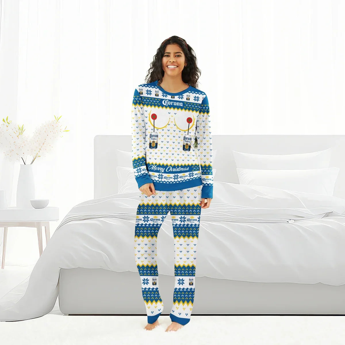 Smiling woman in blue and white Corona Extra Christmas pajamas standing barefoot in a bright bedroom