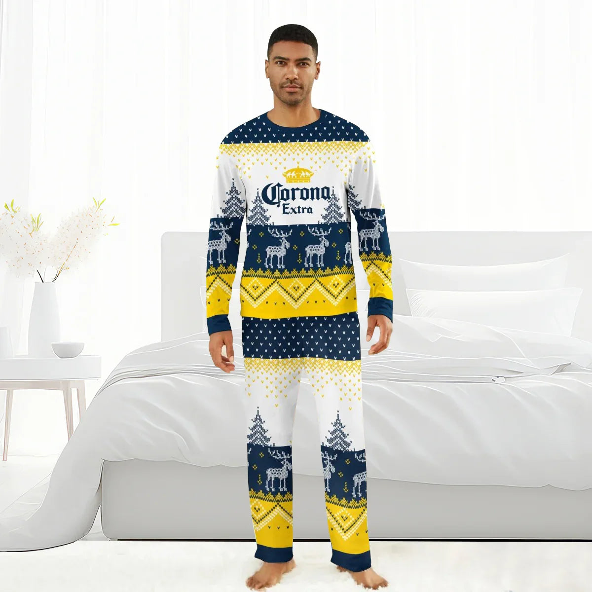 Man wearing Corona Extra winter reindeer family pajama set in white, navy, and yellow in bedroom