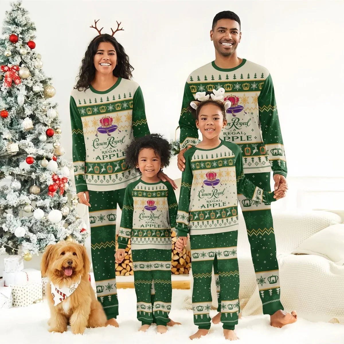 Smiling family in matching Crown Royal Apple Christmas pajamas by decorated tree with dog