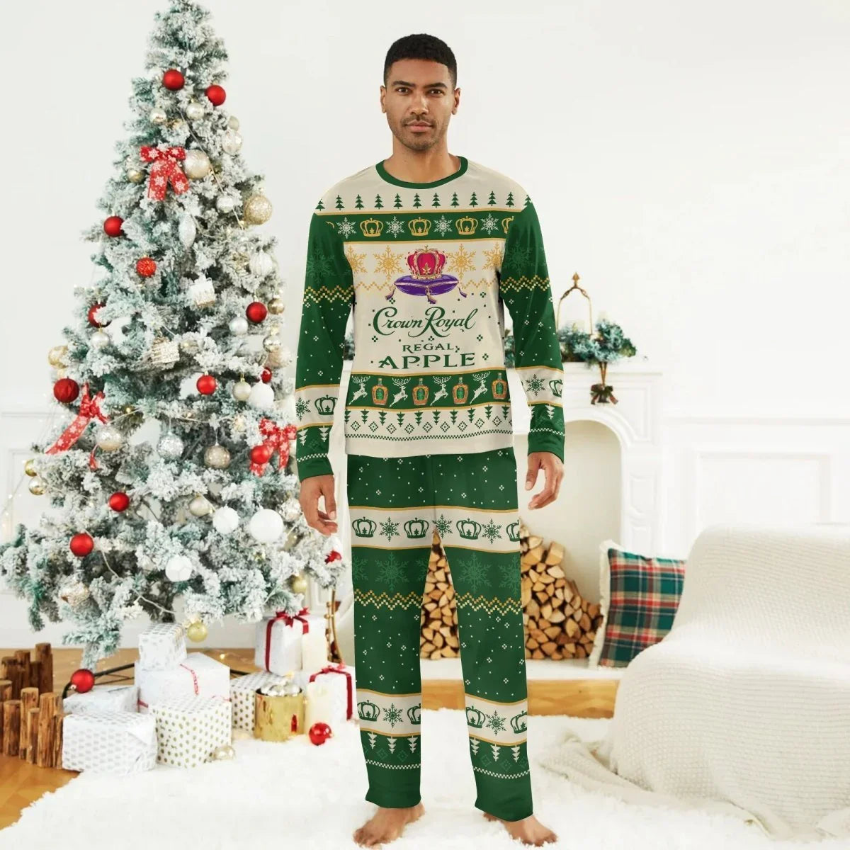 Man wearing Crown Royal Regal Apple Christmas pajamas standing barefoot in decorated living room with Christmas tree and gifts