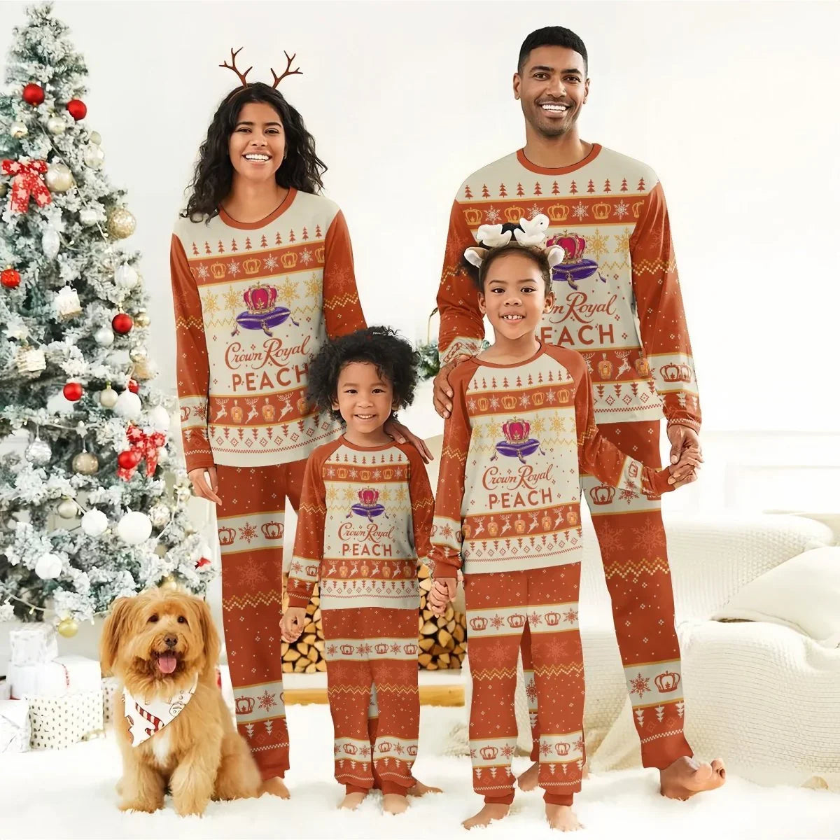 Family in matching Crown Royal Peach holiday pajamas posing by a Christmas tree with a golden dog