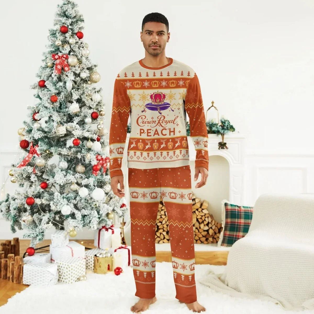 Man wearing Crown Royal Peach holiday pajama set standing by decorated Christmas tree with gifts
