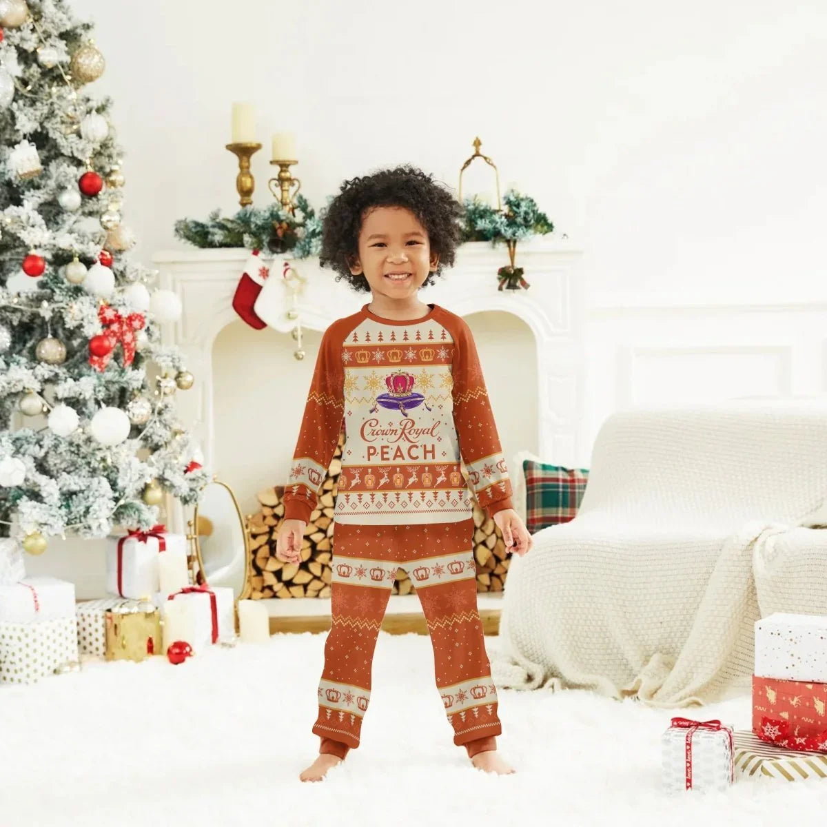 Smiling child in Crown Royal Peach holiday pajamas standing in cozy Christmas living room with decorated tree and gifts