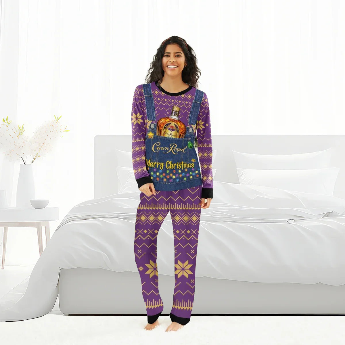 Woman wearing purple Crown Royal Merry Christmas family pajama set with festive patterns, standing by bed