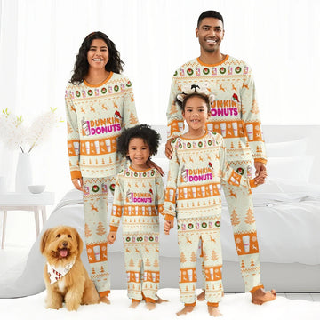 Smiling family in matching Dunkin Donuts Christmas pajamas with festive reindeer patterns, indoors
