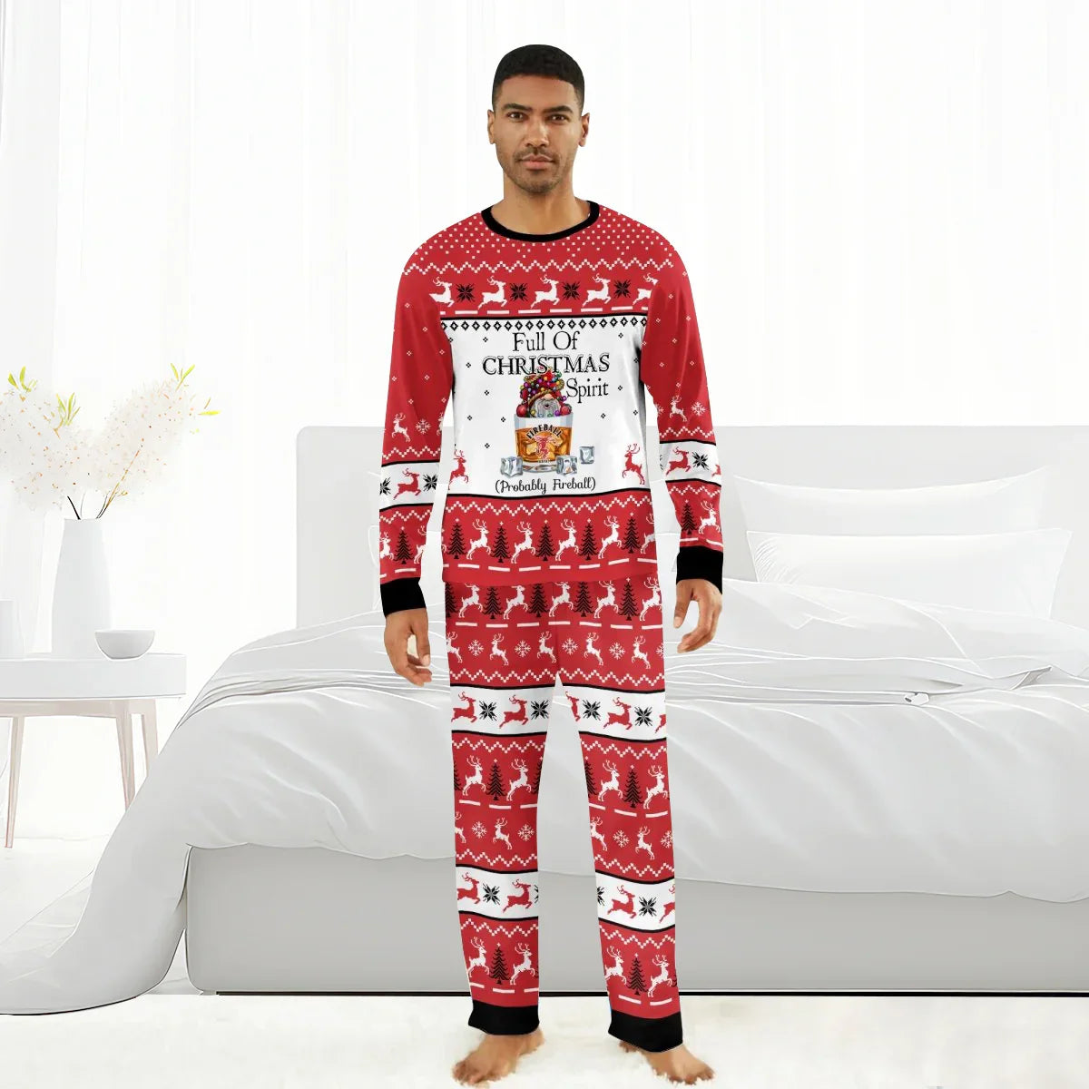 Man wearing red Christmas pajamas with reindeer and tree patterns and Fireball holiday message