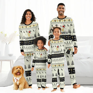 Smiling family in matching Guinness Christmas reindeer pajamas with festive holiday patterns and dog with holiday bandana