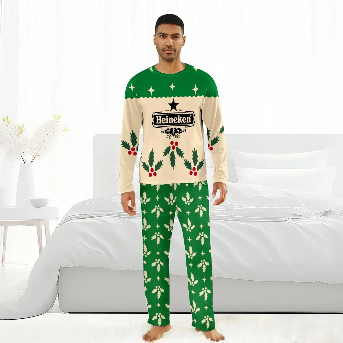 Man wearing Heineken Christmas-themed green and cream holiday pajamas with holly and star patterns in a bright bedroom
