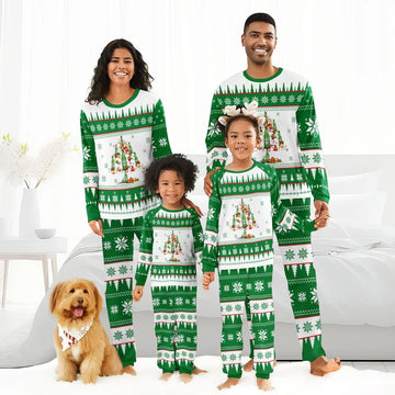 Smiling family in matching green and white Christmas tree pajamas with holiday patterns and a brown dog wearing a festive bandana