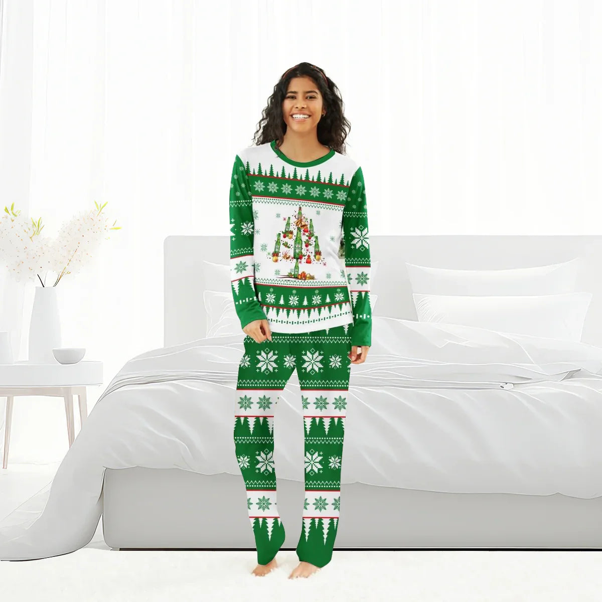 Smiling woman in green and white Christmas pajamas with beer bottle tree design standing in bright bedroom