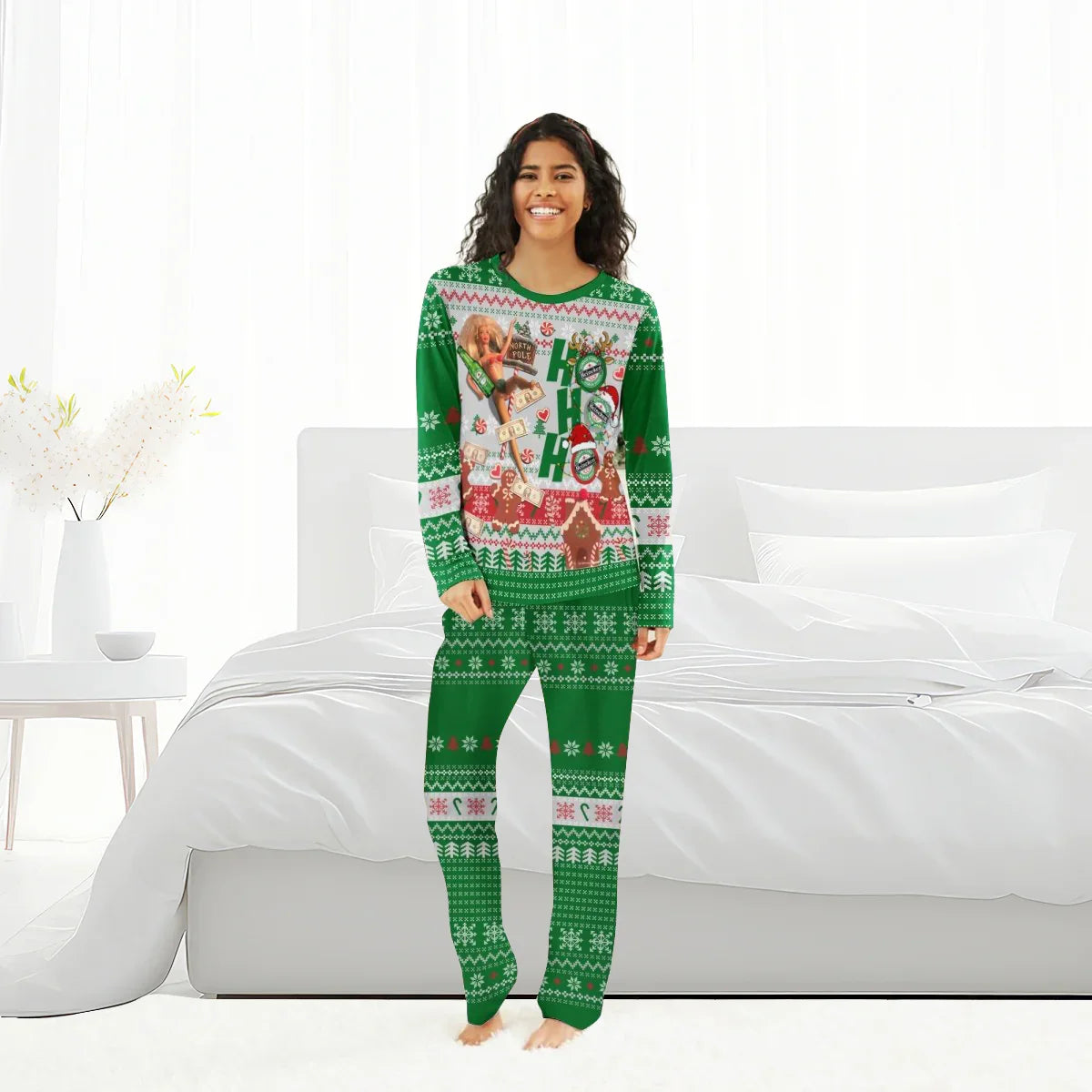 Smiling woman in green Heineken-themed Christmas pajamas standing barefoot in modern white bedroom
