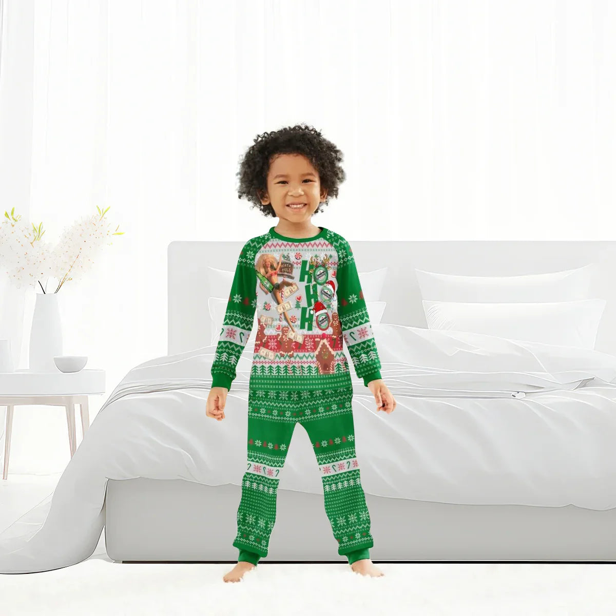 Child in green Christmas-themed pajamas with Ho Ho Ho and festive patterns standing in a bright bedroom