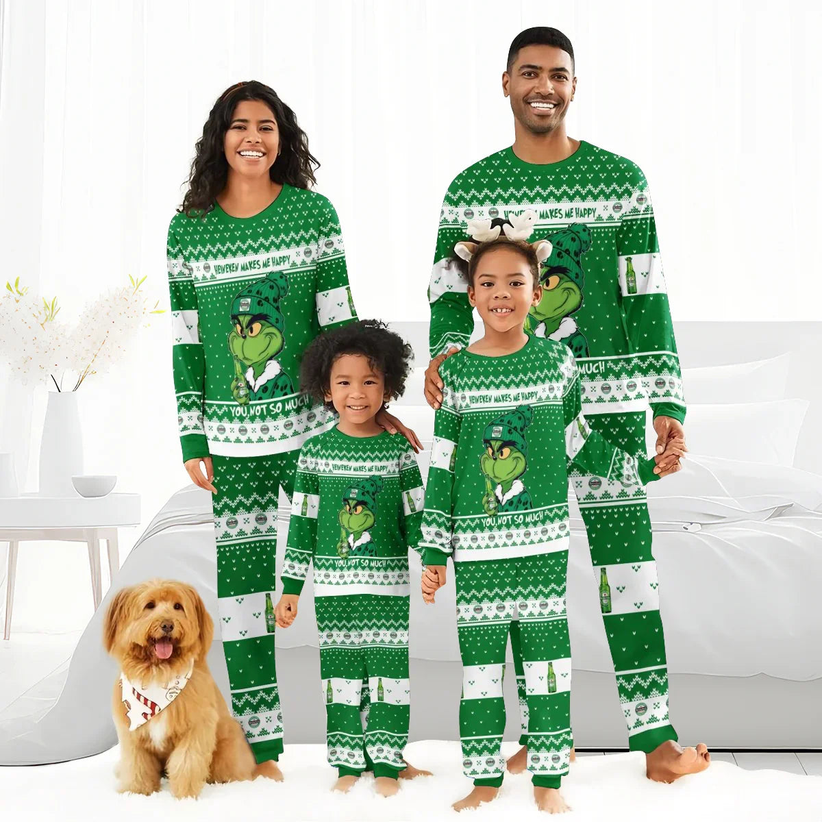 Happy family and dog in green Grinch-themed Christmas pajamas in cozy bright bedroom