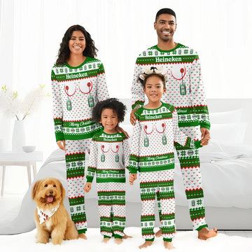 Family of four in matching Heineken Christmas pajamas posing in bright bedroom with a dog