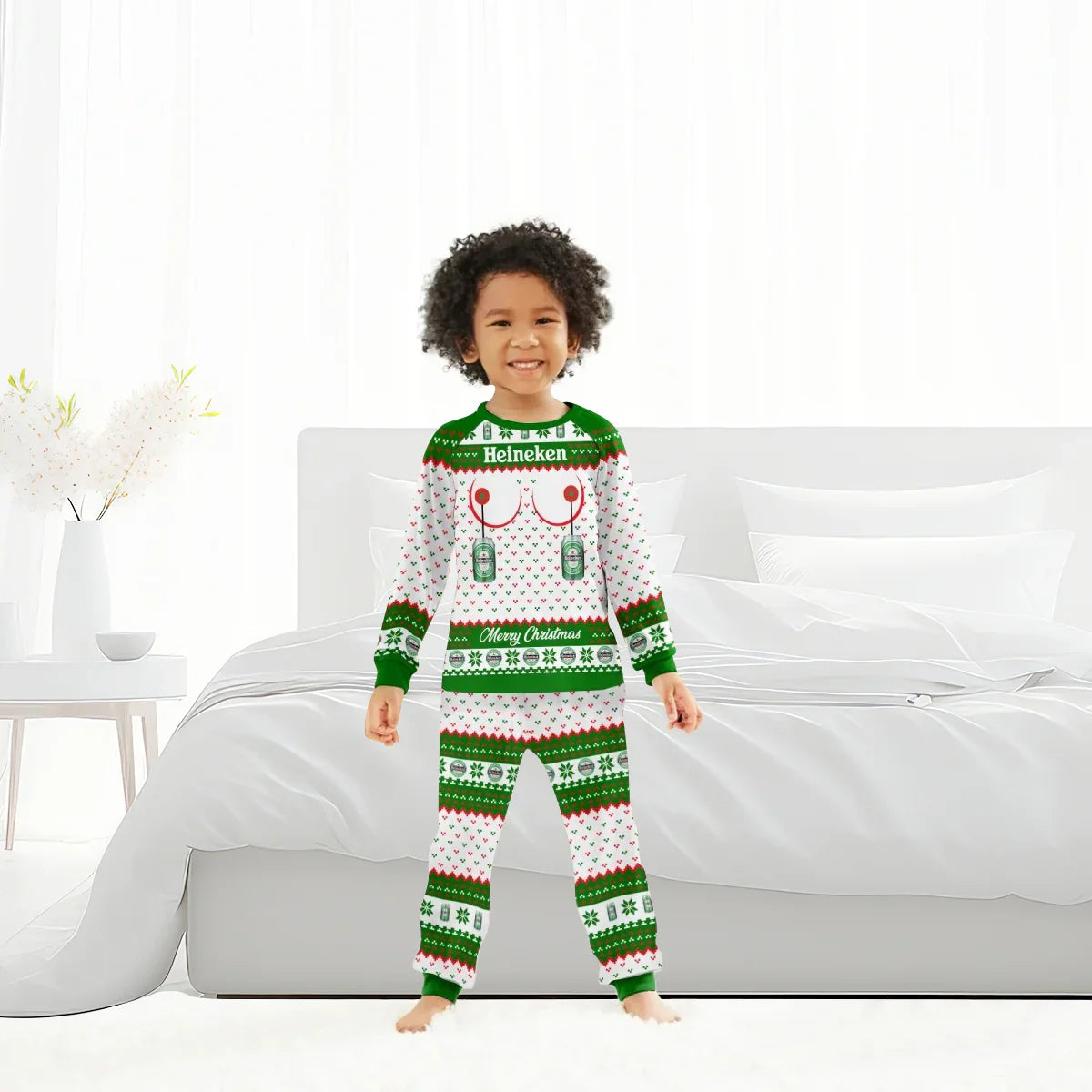 Child wearing Heineken Merry Christmas family pajamas in white, green, and red in a bright bedroom