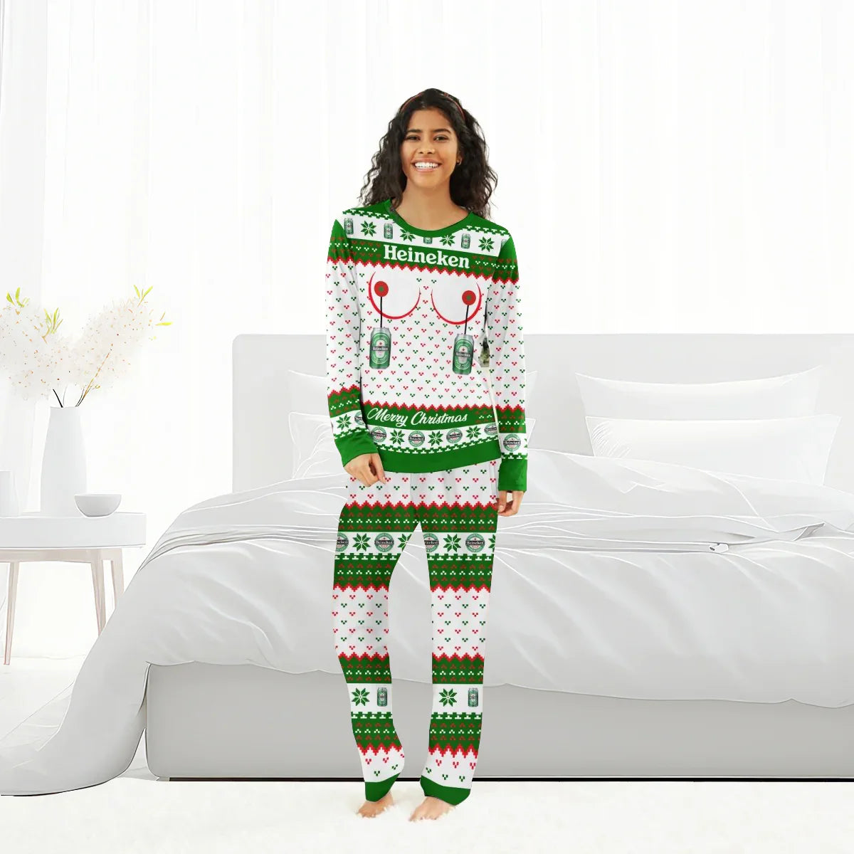 Woman in Heineken Merry Christmas family pajamas set standing in a bright bedroom with white bed and decor