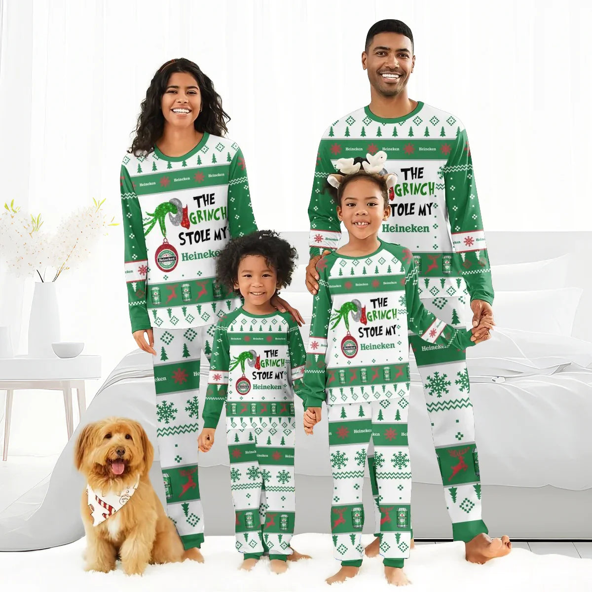 Family wearing green and white Heineken Grinch-themed Christmas pajamas with dog in festive bandana