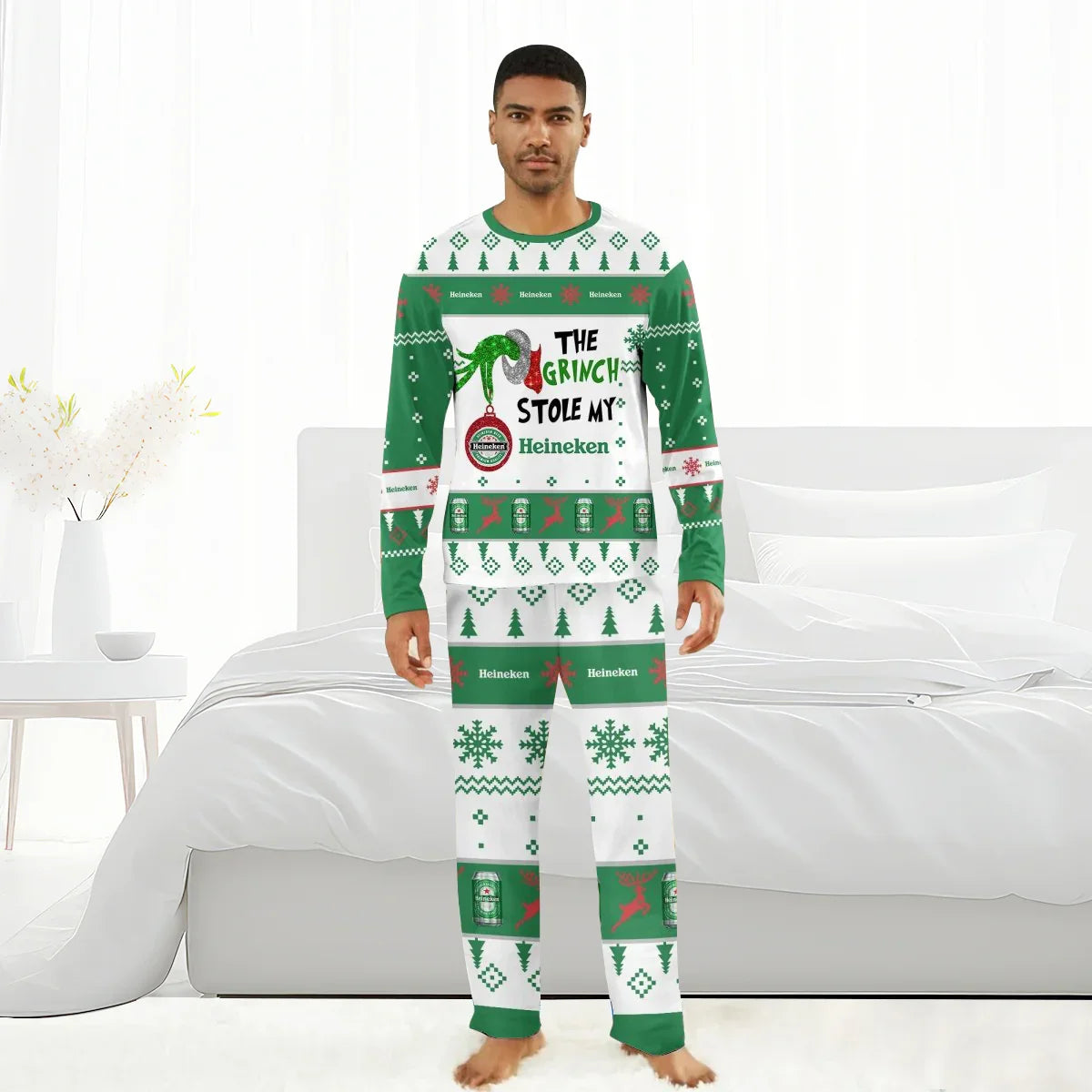 Man wearing green and white Heineken Grinch-themed Christmas pajamas with holiday patterns