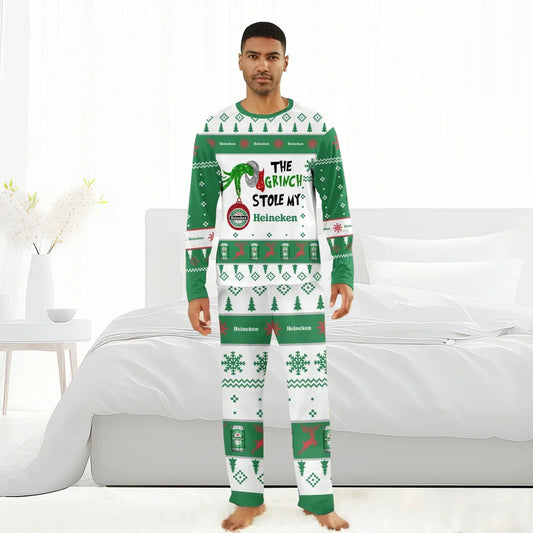 Man wearing green and white Heineken Grinch-themed Christmas pajamas with holiday patterns