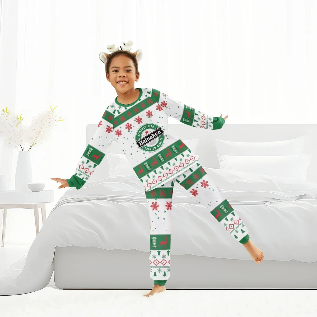 Child wearing Heineken Christmas holiday pajamas with festive snowflakes and reindeer in white bedroom