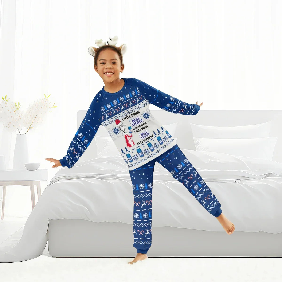 Child wearing blue Christmas pajamas with Bud Light and holiday patterns in a bright bedroom