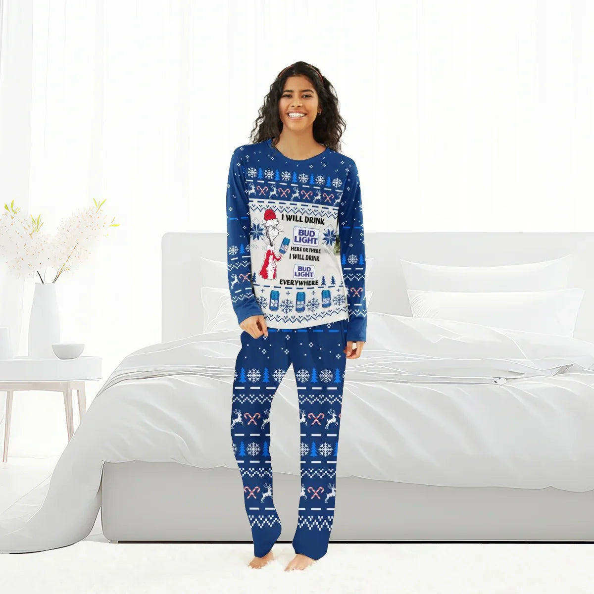 Smiling woman in blue Bud Light Christmas family pajamas with snowflakes, reindeer, and candy cane patterns